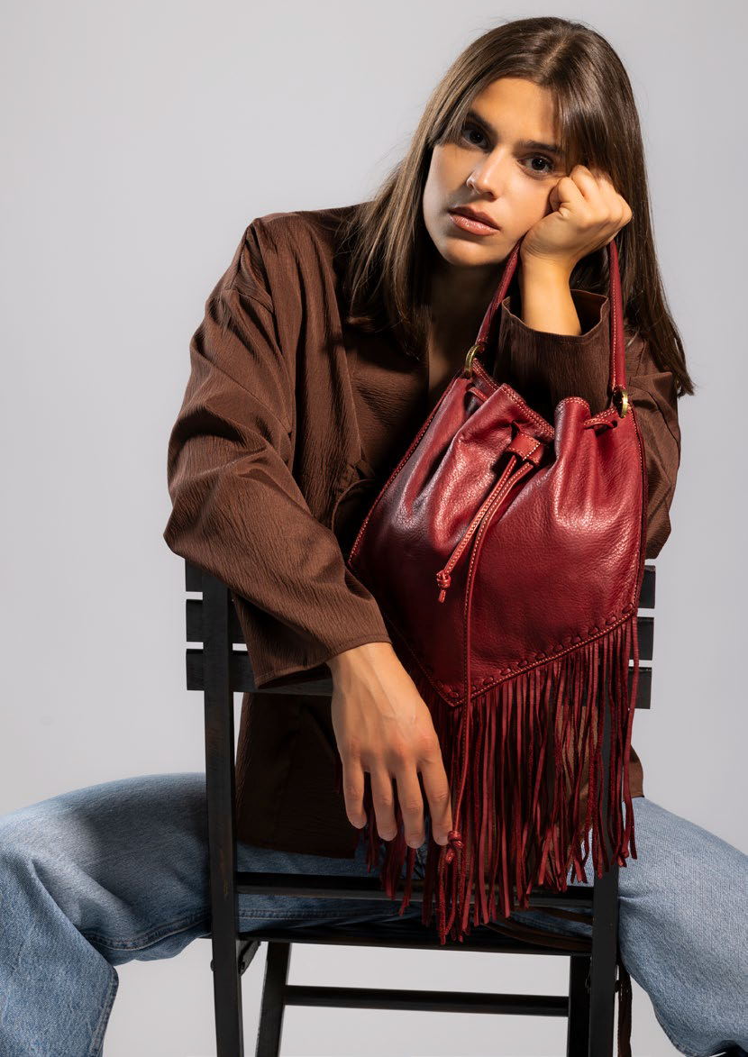 Adelaide Red Cardinal leather fringe bucket bag by Caterina Lucchi, front view on white background