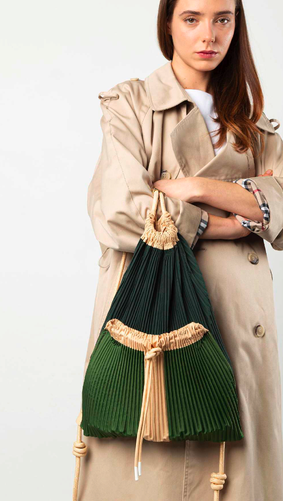 Multitudes Cini backpack worn on shoulder with pleated design