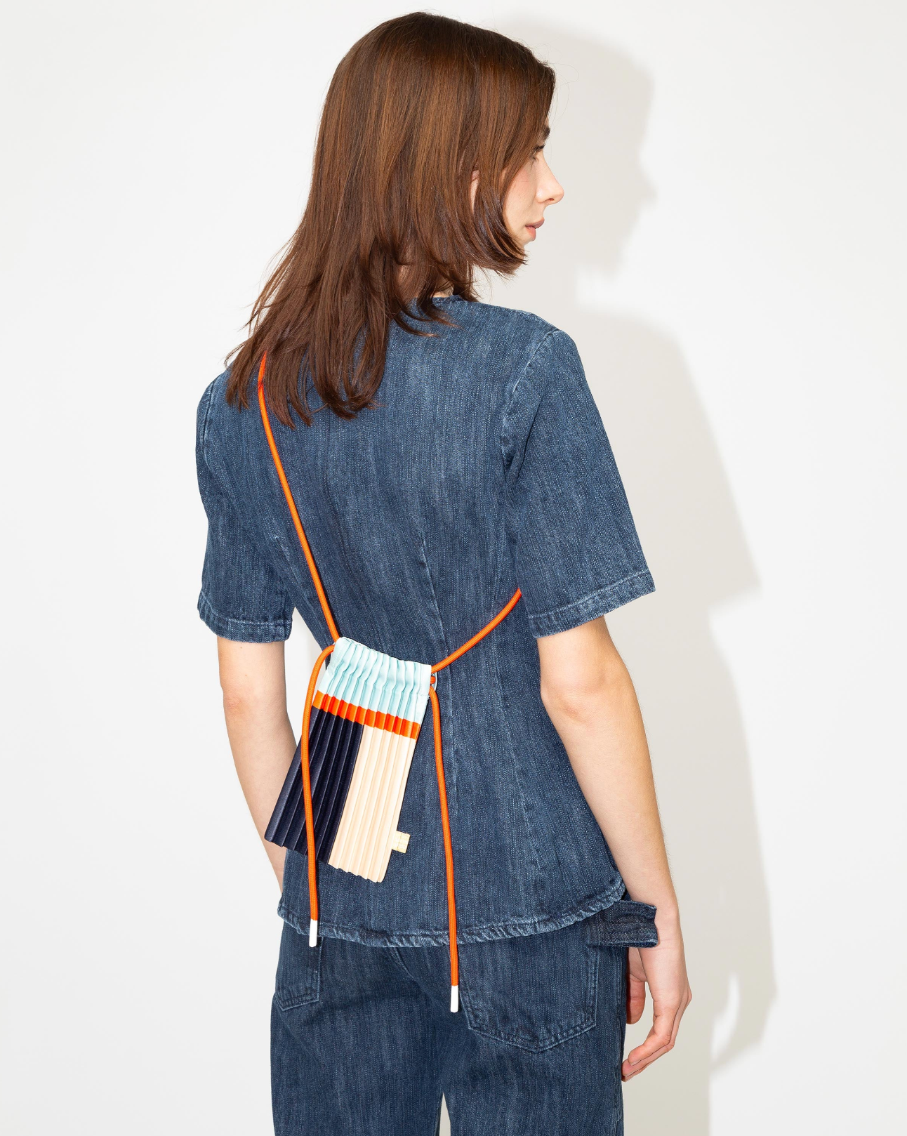 Multitudes pleated mini bag blue multicolor worn on the back rear view