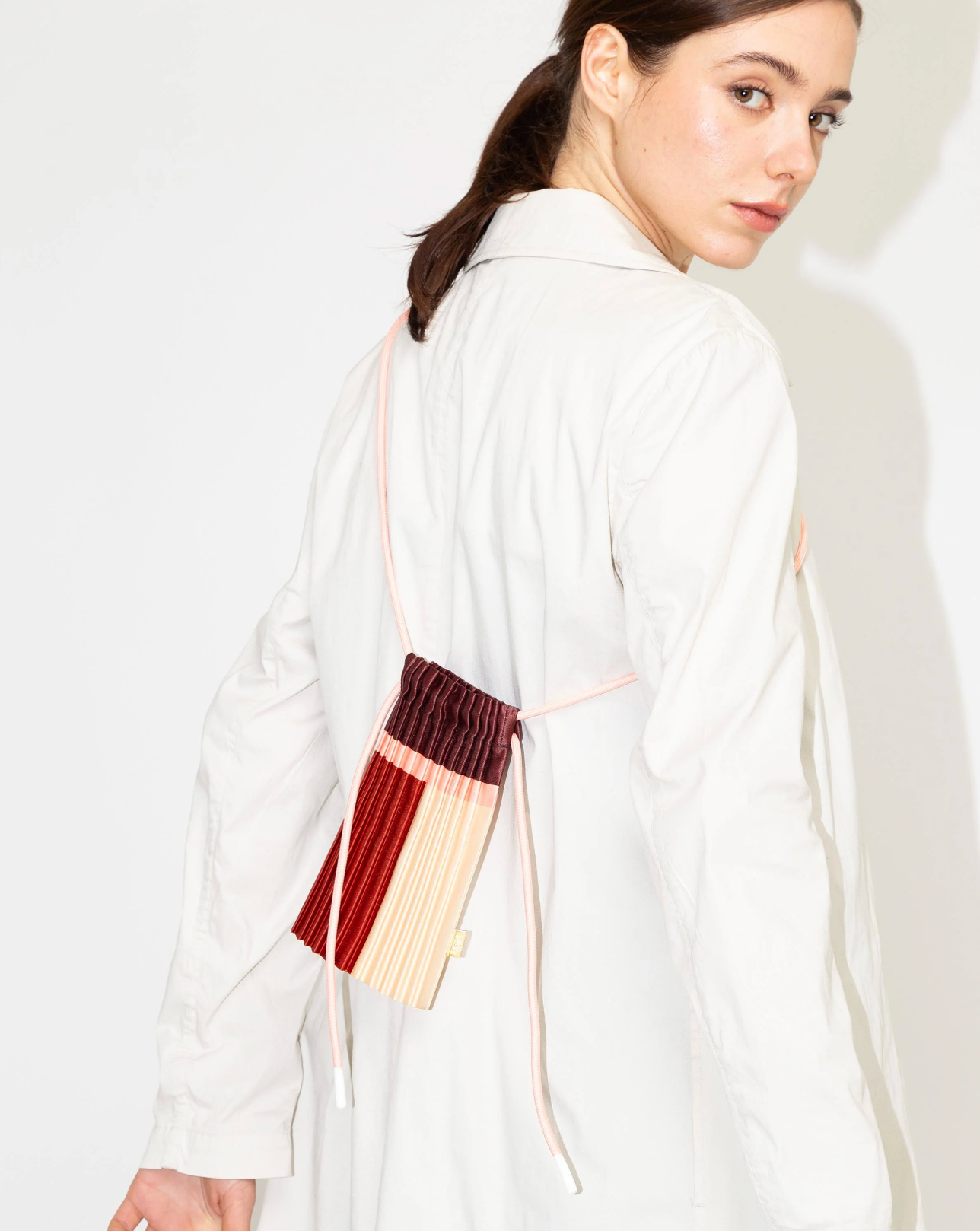 Multitudes pleated mini bag Rubi burgundy red worn crossbody back view