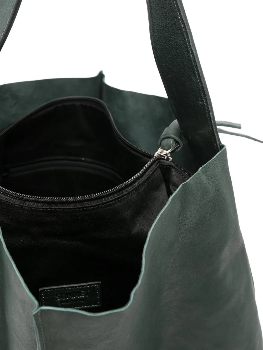 Sommet Sahara bucket bag in deep cadet green vegetable-tanned leather with removable interior pouch and waxed artisanal finish, handmade in Italy.