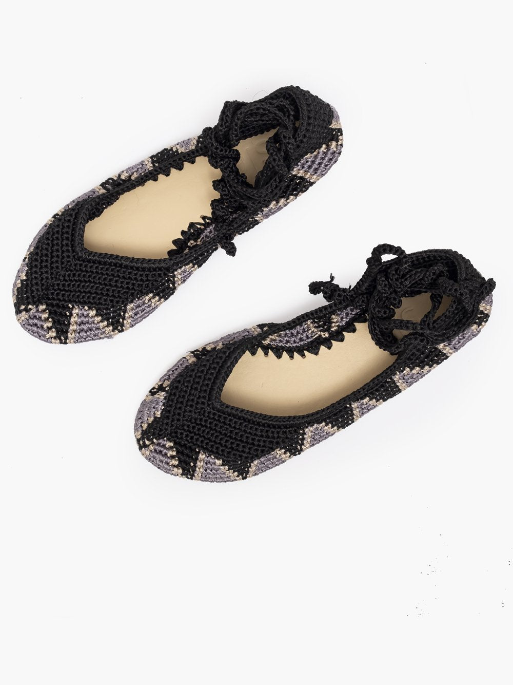 Bailarinas planas de punto crochet tejidas a mano en color negro, gris y blanco, con cierre de tiras romanas. Están realizadas en algodón y rayón teñidos a mano con tintes naturales, esta combinación de materiales hace que sean un poco elásticas lo que les da un ajuste perfecto y gran comodidad. Perfectas para resaltar cualquier look. Exterior: 60% Rayón, 40% Algodón Interior: Cuero 100% Suela: Goma 100% Color: Moonless_Black