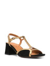 Load image into Gallery viewer, Sandalia Chie Mihara LIPE de tacón medio en ante negro con detalles dorados, tira al tobillo y cierre con hebilla lateral. Diseño elegante y cómodo, hecho en España