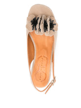 Load image into Gallery viewer, Sandalia Chie Mihara modelo NILOLA en piel beige con tacón medio y aplique de flor, vista lateral con cierre de hebilla y diseño artesanal.