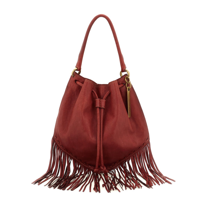 Adelaide Red Cardinal fringe bucket bag by Caterina Lucchi, worn on shoulder by female model
