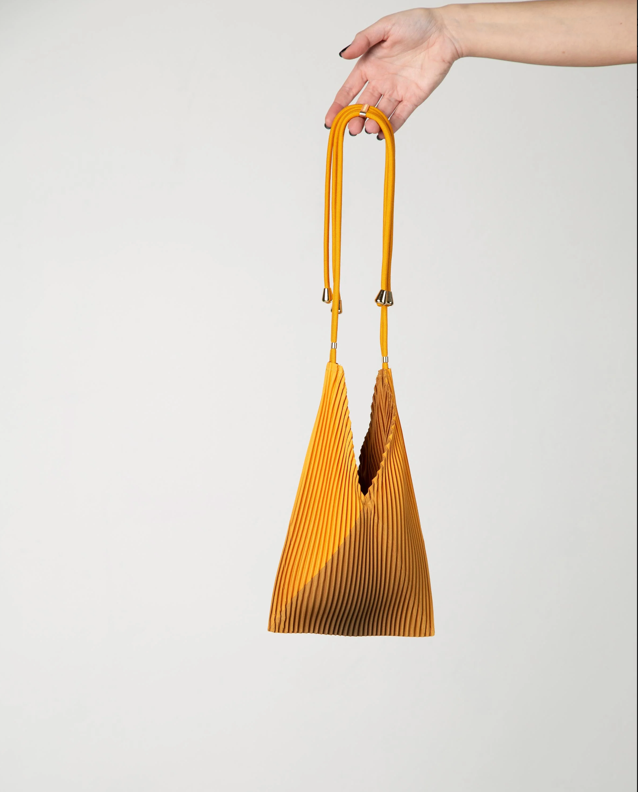 Multitudes pleated baby bag Artisan gold worn crossbody front view
