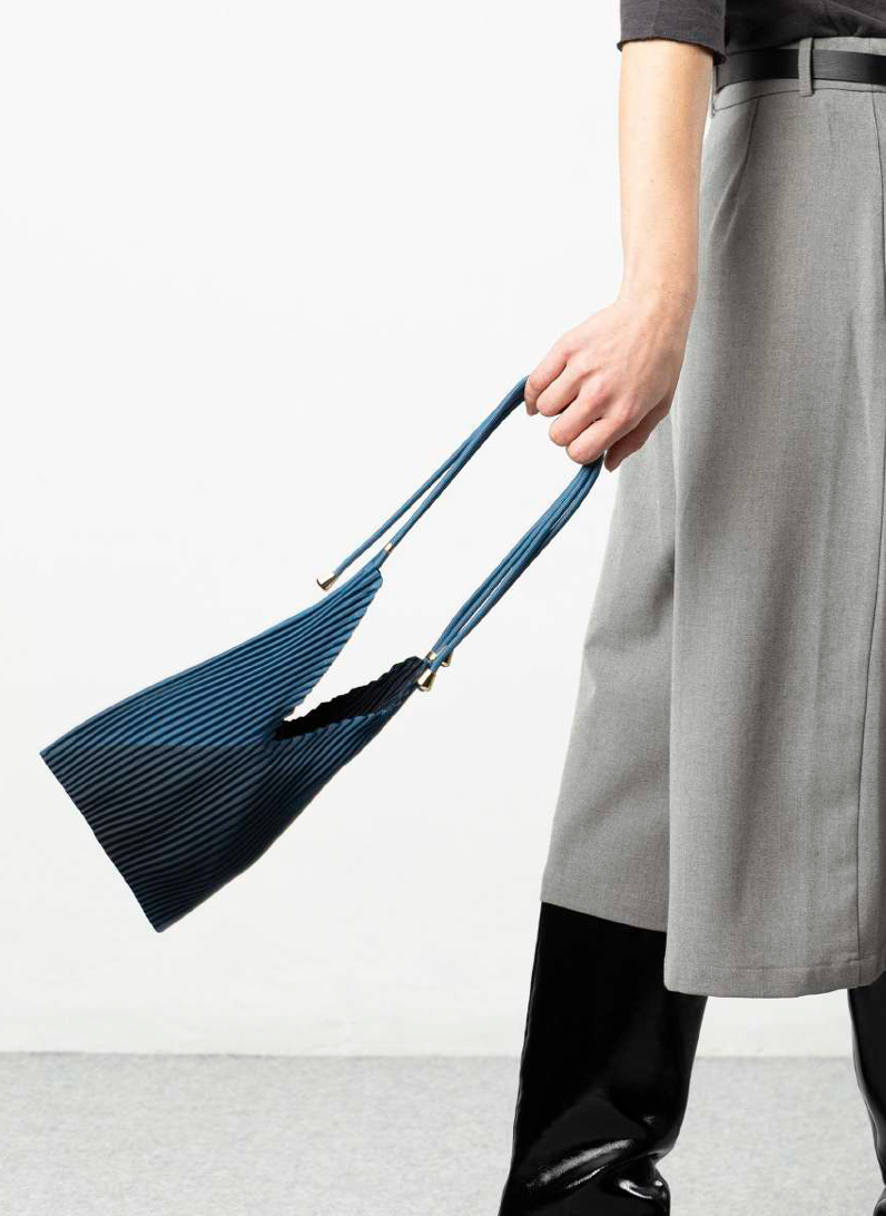 Multitudes pleated baby bag Moroccan blue indigo worn crossbody model side view
