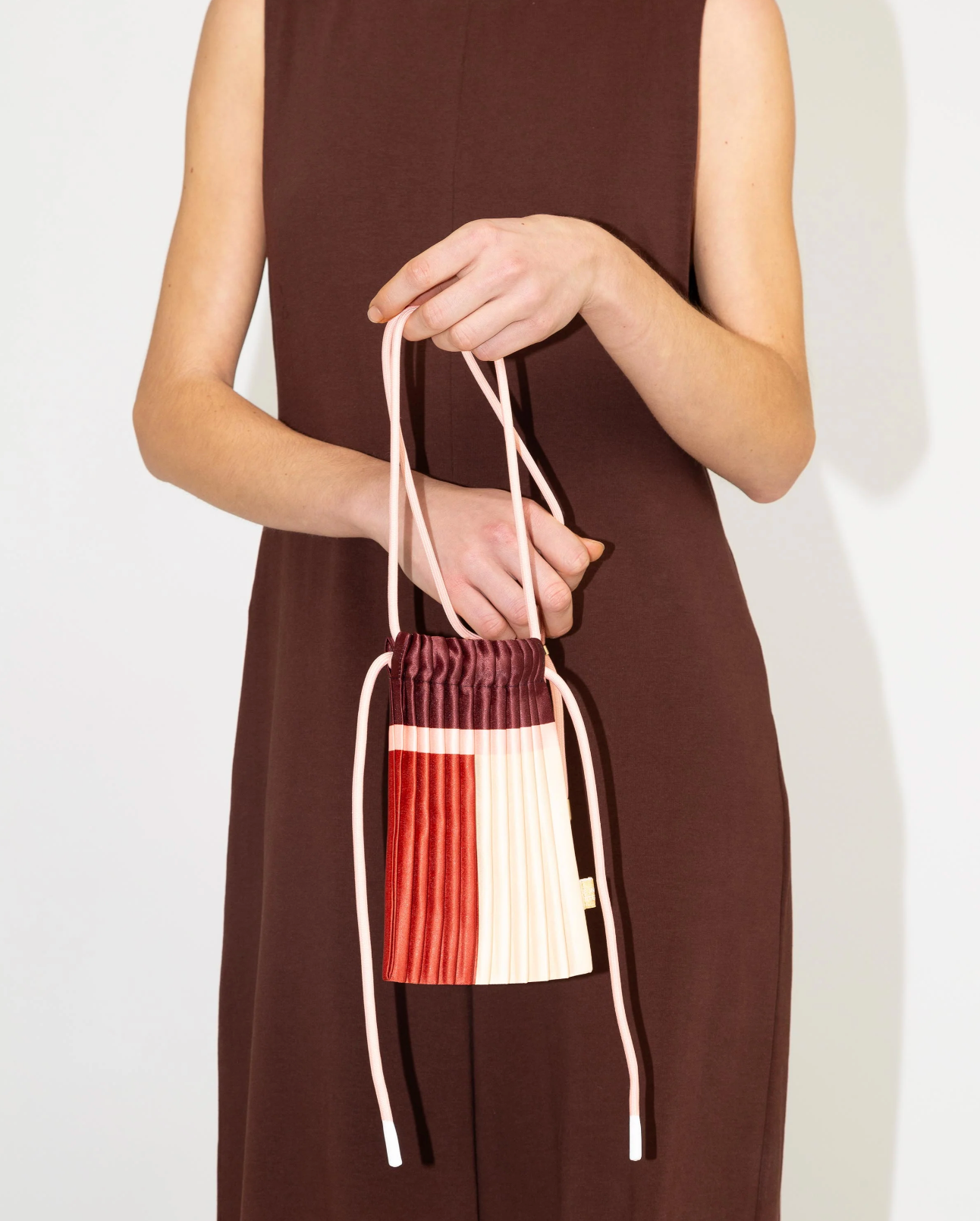 Multitudes pleated mini bag Rubi burgundy red worn crossbody front view
