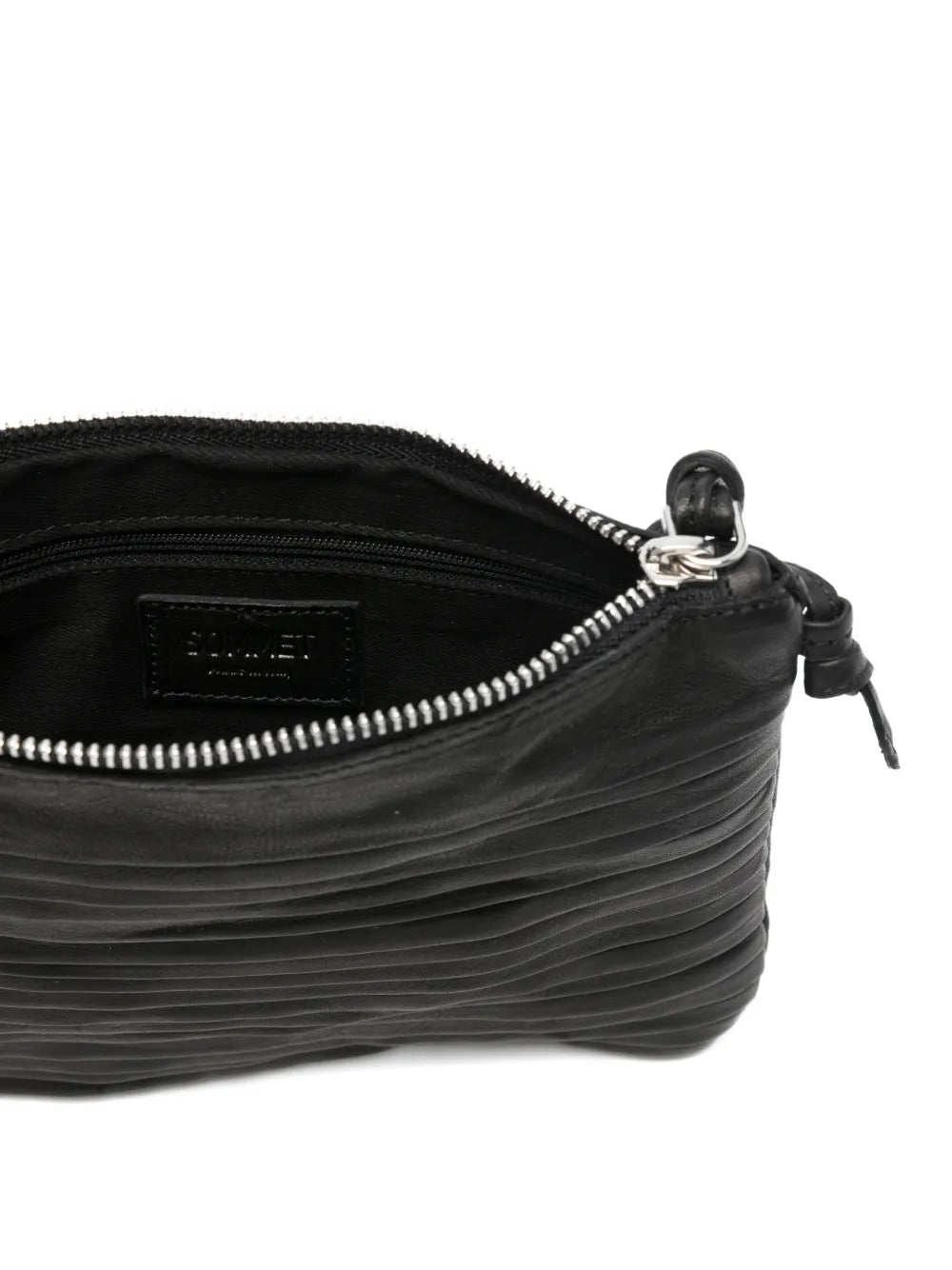 Small black leather crossbody bag with fine horizontal pleated details and adjustable strap, handcrafted in Italy, displayed against a white background.
