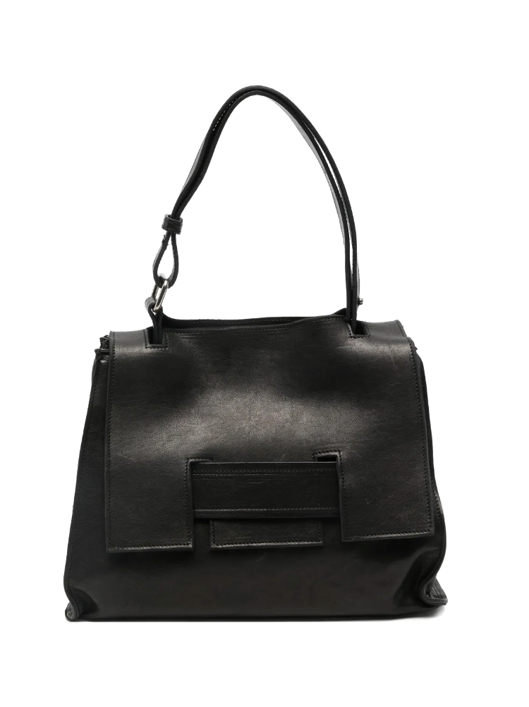 Black structured leather handbag with geometric flap and adjustable strap, handcrafted in Italy.