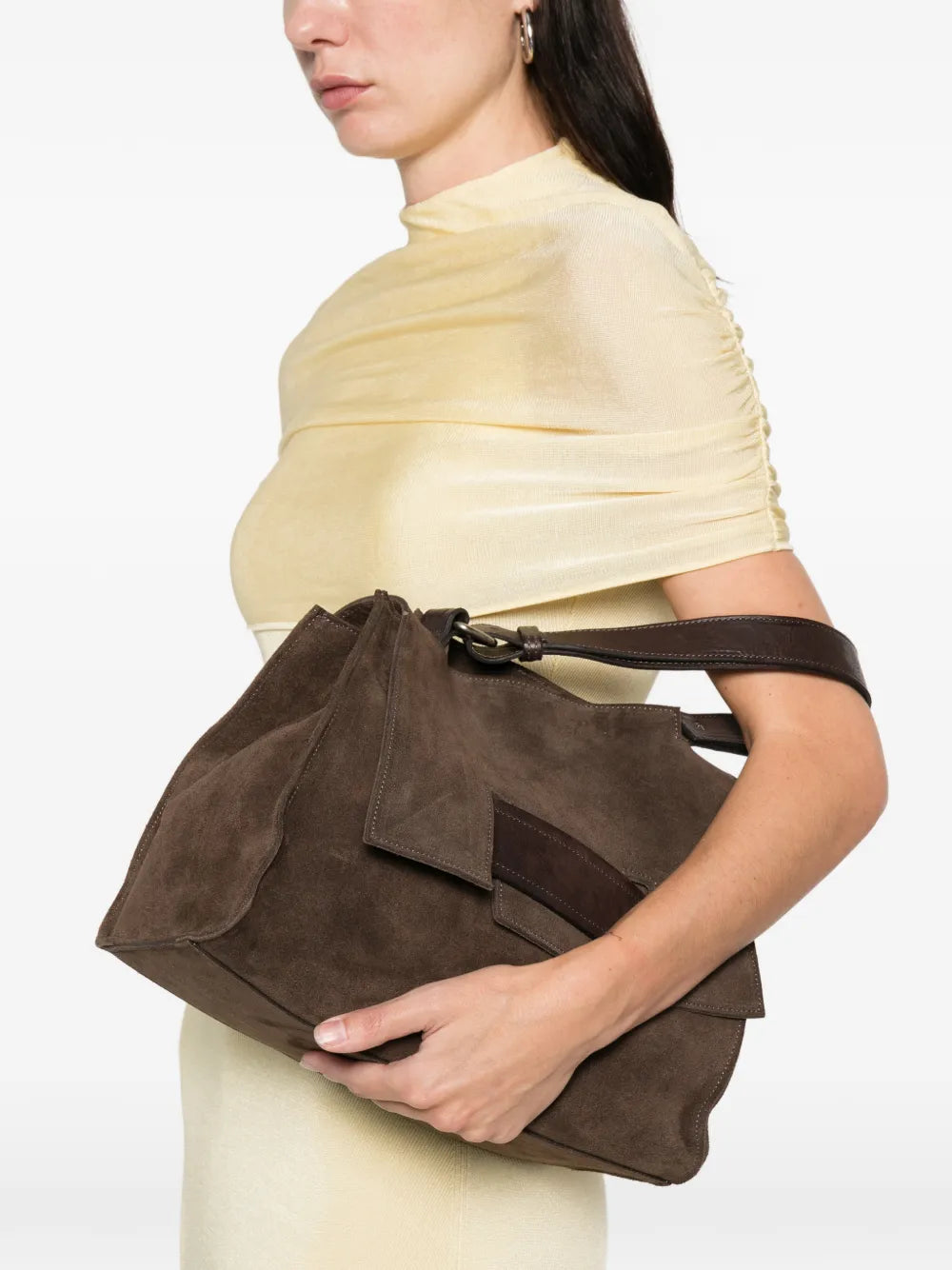 Brown suede structured handbag with geometric flap and adjustable strap, handcrafted in Italy.