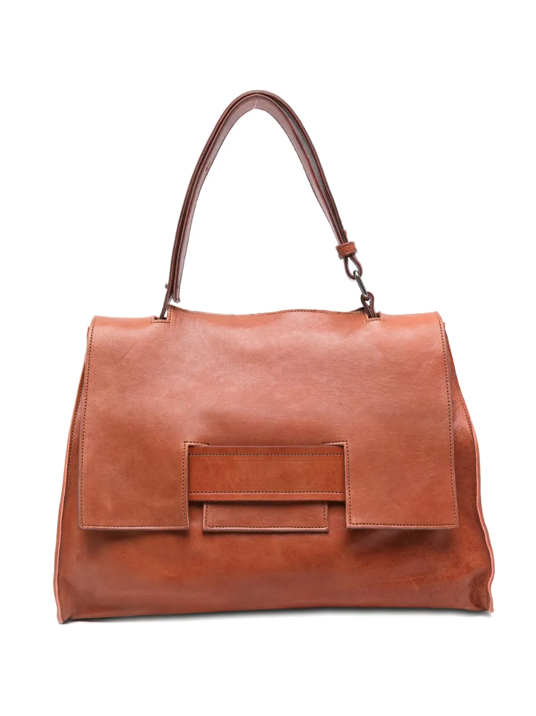 Sommet Mayway Little siena leather handbag carried by hand, structured silhouette with geometric flap detail, handcrafted in Italy.