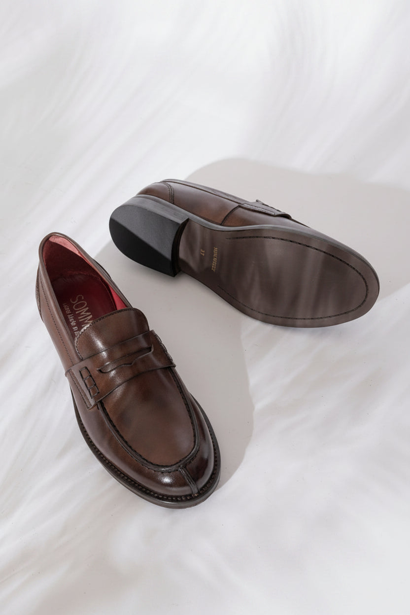 SOMMET penny loafer in Old Brown leather with flexible sole and low heel. Handmade in Italy with vegetable tanning. Classic, timeless style built to last.
