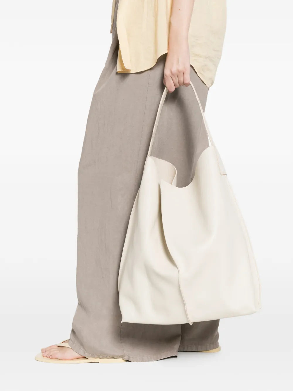 Sommet Sahara ivory leather bucket bag in vegetable tanned leather with artisanal waxed finish, handcrafted in Italy.